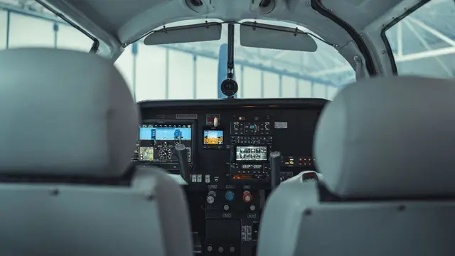 Finished Garmin avionics panel in a single-engine cockpit, seen from the rear seats