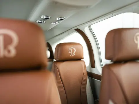 Bonanza cabin with custom tan leather seats and embroidered headrests