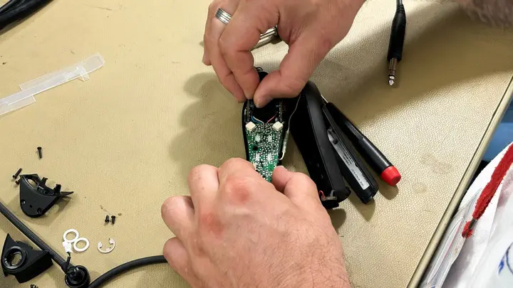 Headset control module opened on the bench for repair