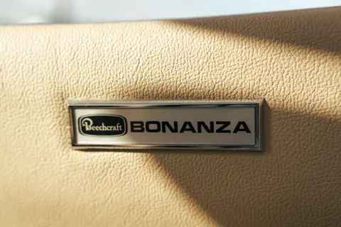 Close-up of an aircraft nameplate on a leather panel