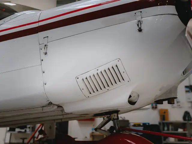Cooling louver on the engine cowling of a white aircraft