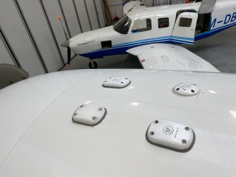 Antennas mounted on the top of an aircraft fuselage in the hangar