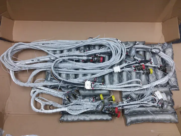 Several finished harness assemblies packed in a shipping box