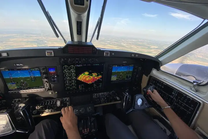 King Air cockpit in flight with the Garmin G1000 NXi displays showing weather radar