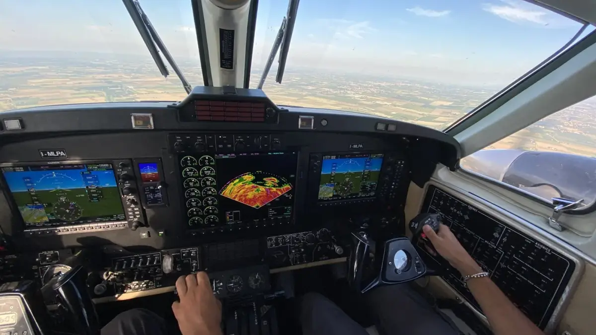 King Air cockpit in flight with the Garmin G1000 NXi displays showing weather radar