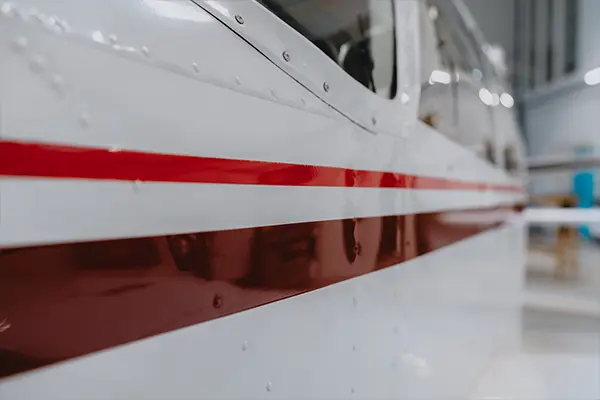 Red stripe on a white fuselage after paint correction