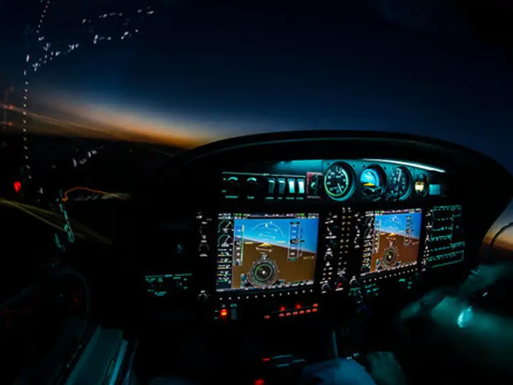 Cockpit at night with illuminated panel legends