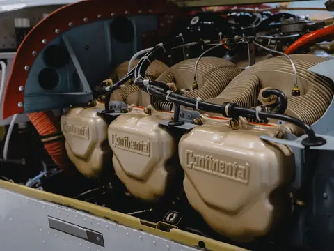 Piston engine bay with cowling open, showing baffles and baffle seals around the cylinders