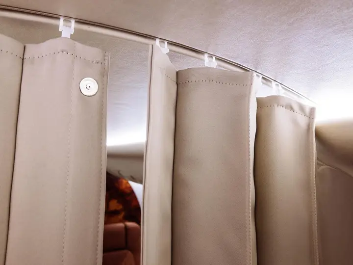 Cabin curtains hanging from a curved rail in a business jet